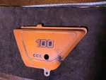 Suzuki 1978 TS100 Oem Side Cover , 47211-48000-05M. Fixed Price $49.00.